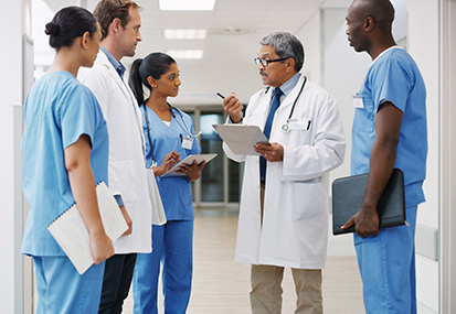 medical professional end of life care training image hospital staff in discussion by project compassion